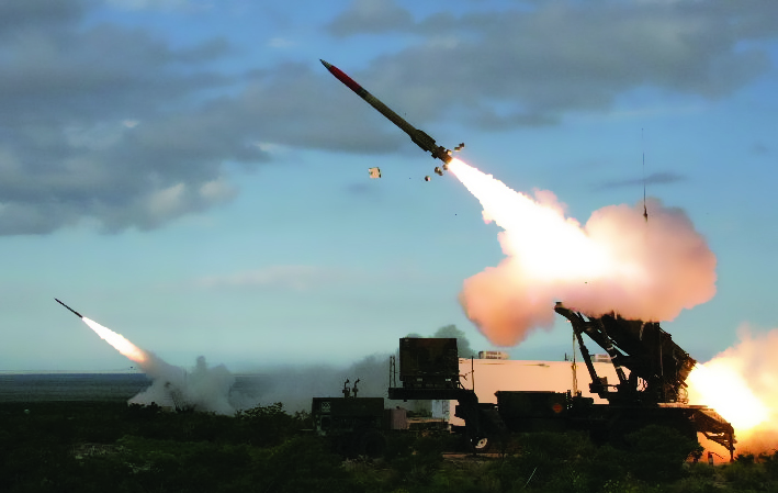 Multiple air defense missile systems firing simultaneously in bright daylight