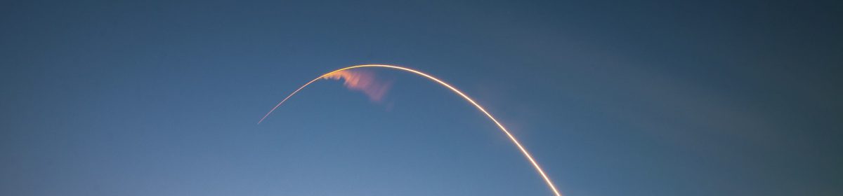 Missile launch arc against evening sky