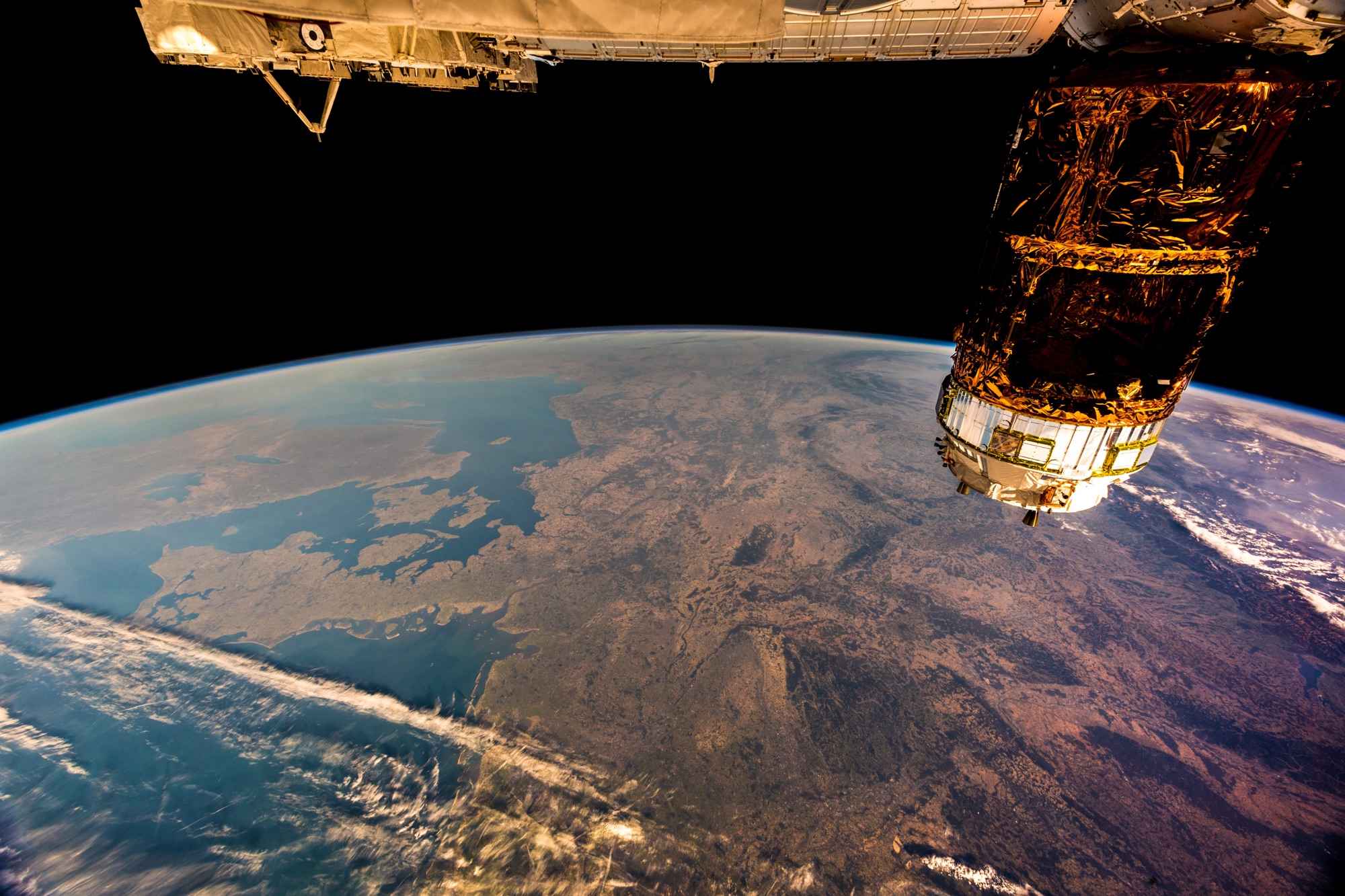 Space station with solar panels near Earth's curvature