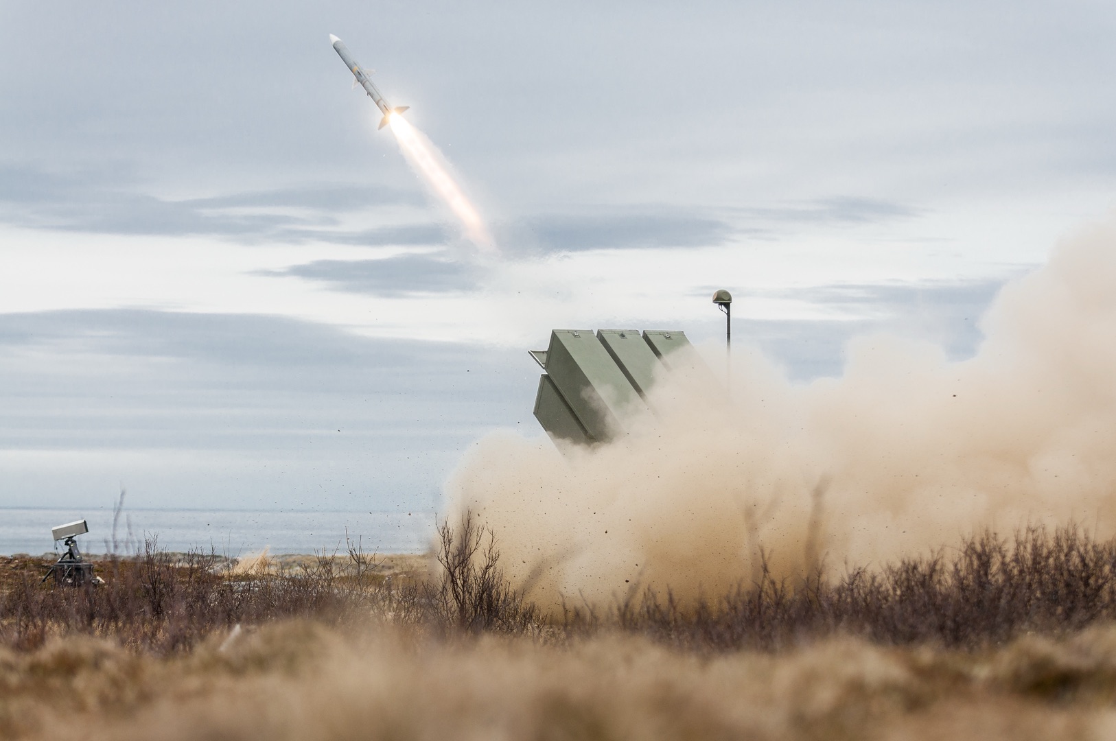 NASAMS missile launcher firing in a Nordic landscape