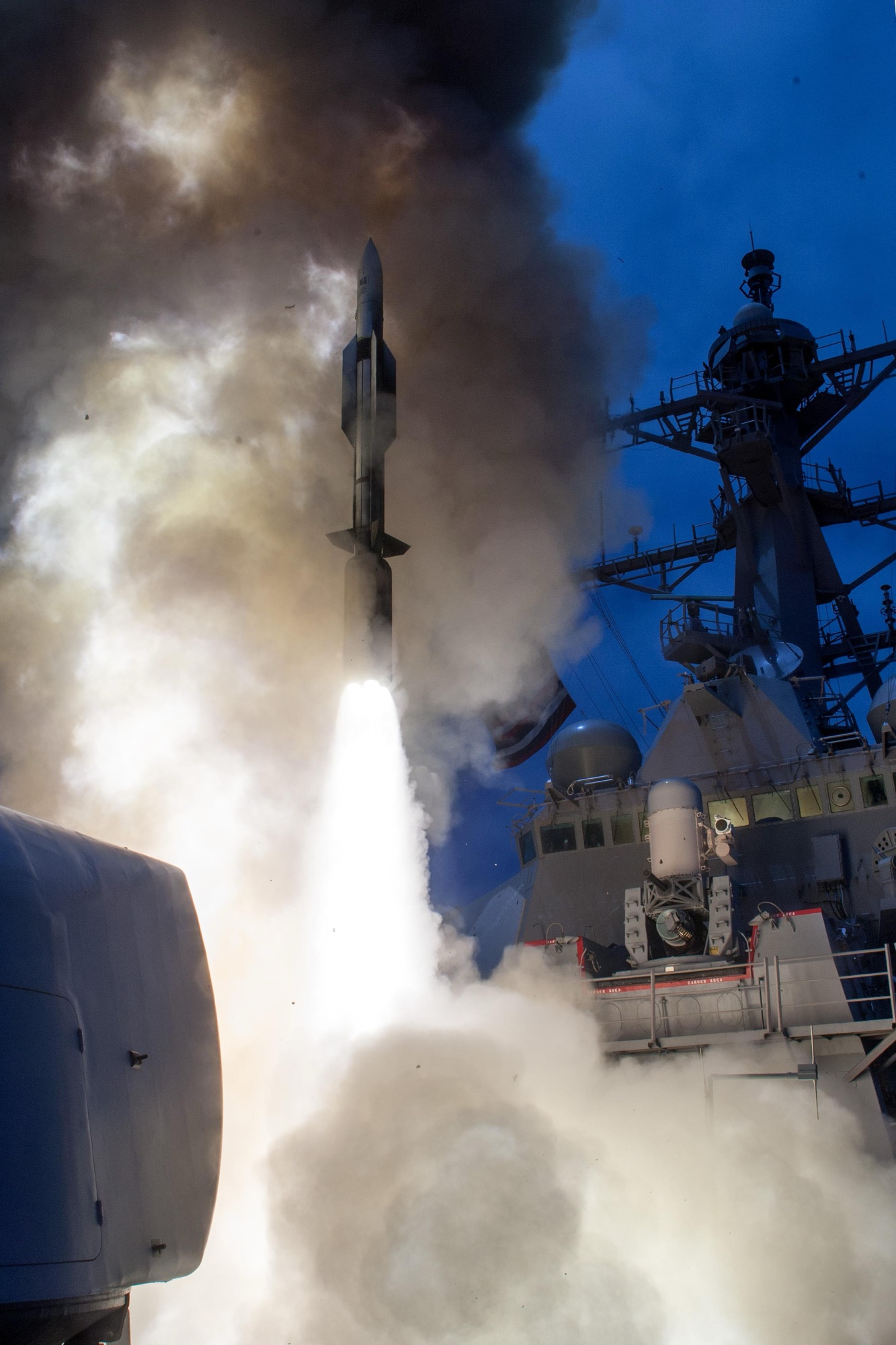SM-6 missile launching from a destroyer at dusk